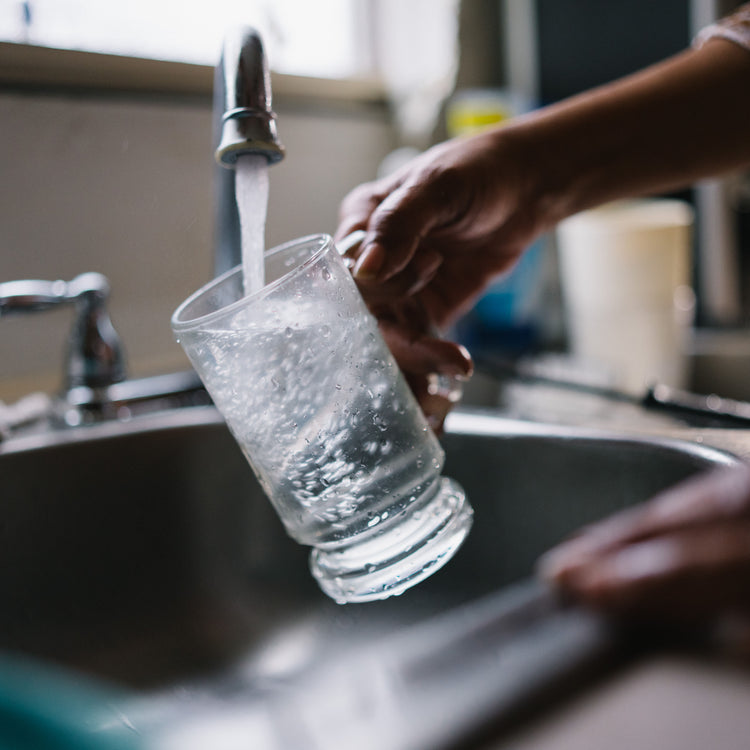 Pouring water into a cup as part of the pronounce commitment - Appalachia Water Project